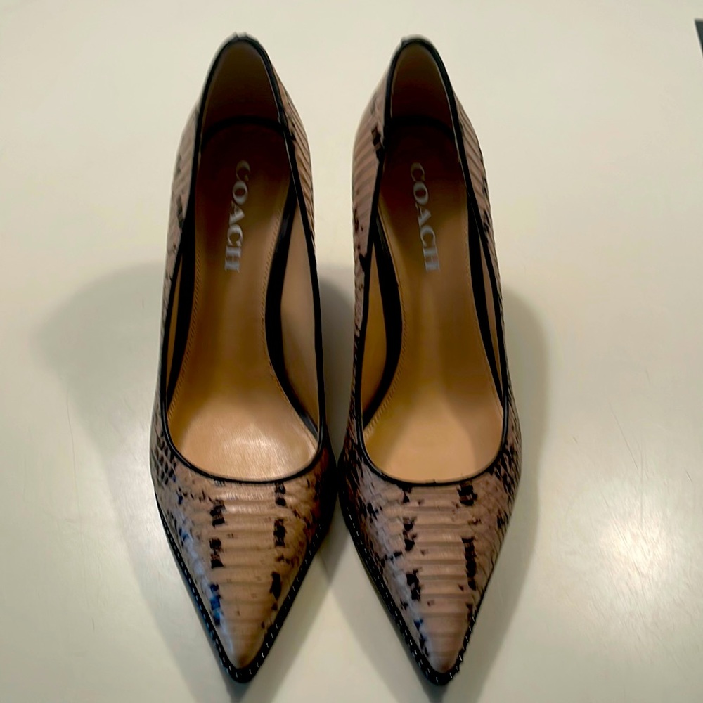 Tan and black Coach pumps.